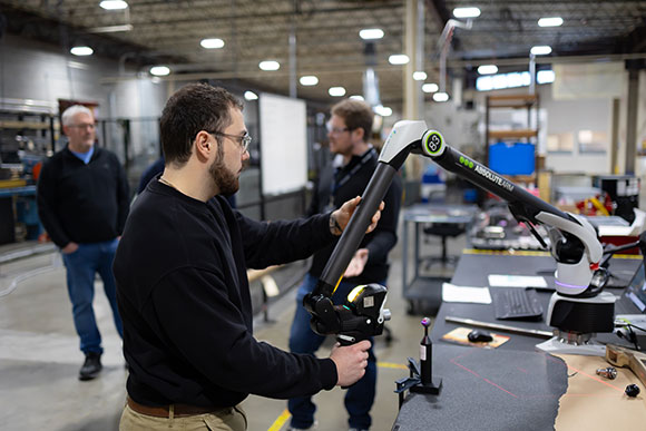 Hydrasearch employees discussing products at an industry event