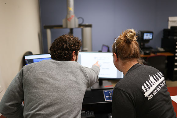 Two Hydrasearch colleagues collaborating at a computer workstation
