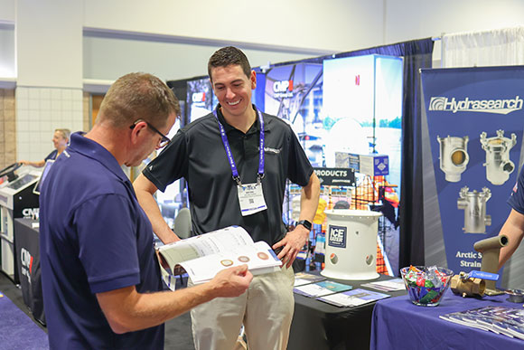 Hydrasearch representative speaking with an event attendee