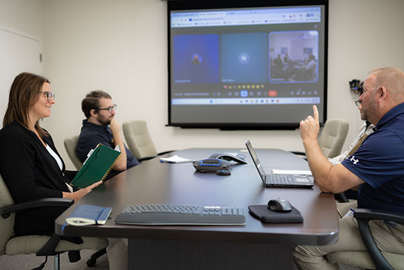 Hydrasearch employees in meeting room